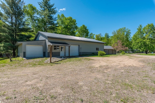 8296 Gladstone Lake Rd, Lake Edward Twp, MN 56401 - view of home's exterior featuring a detached garage, metal roof, and an outdoor structure