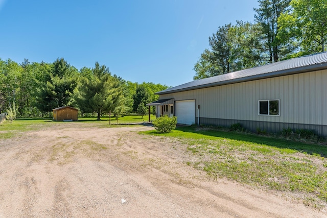 8296 Gladstone Lake Rd, Lake Edward Twp, MN 56401 - view of grassy yard with an outdoor structure, dirt driveway, and a garage