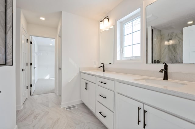 20117 63rd Ave, Corcoran, MN 55340 - full bathroom with double vanity, a marble finish shower, recessed lighting, marble finish flooring, and a spacious closet