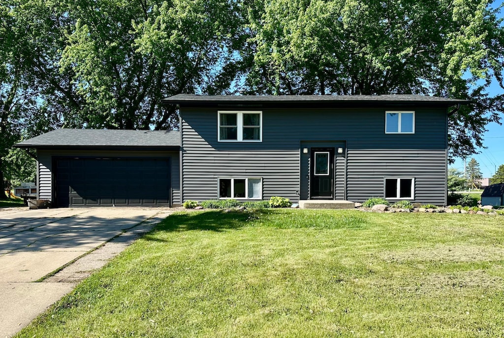 505 Meadow Lark Ln, Dodge Center, MN 55927 - bi-level home with a garage, driveway, and a front yard