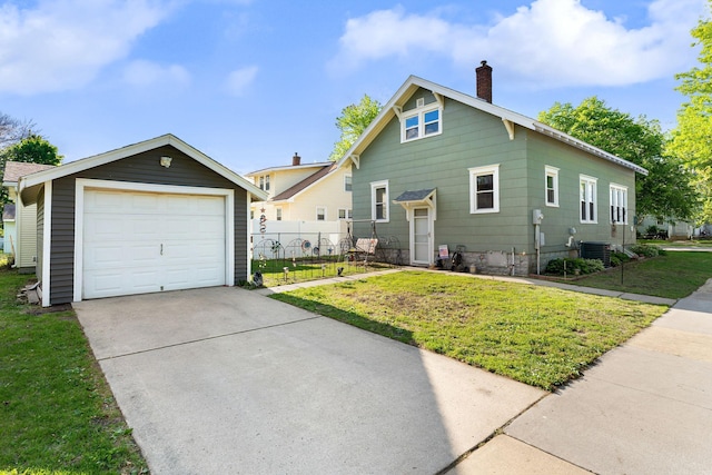 1001 2nd Ave SW, Austin, MN 55912 - view of front facade with cooling unit, a chimney, concrete driveway, an outdoor structure, and a detached garage
