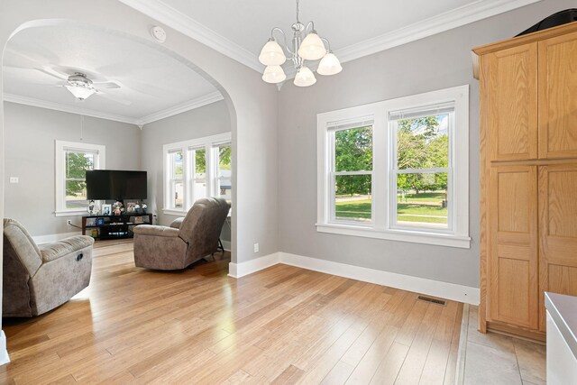 1001 2nd Ave SW, Austin, MN 55912 - living area with arched walkways, crown molding, light wood-style flooring, a chandelier, and a ceiling fan
