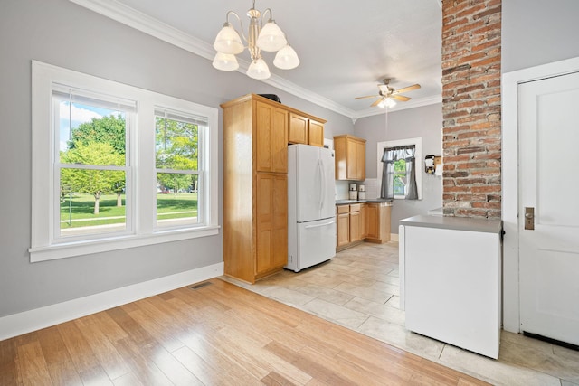 1001 2nd Ave SW, Austin, MN 55912 - kitchen with freestanding refrigerator, crown molding, ceiling fan, baseboards, and light wood-style floors