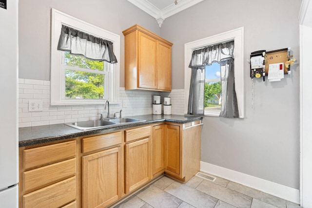 1001 2nd Ave SW, Austin, MN 55912 - kitchen with a sink, ornamental molding, backsplash, dark countertops, and freestanding refrigerator