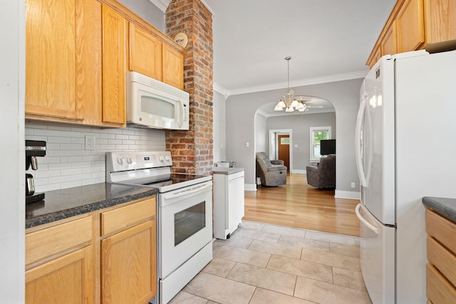 1001 2nd Ave SW, Austin, MN 55912 - kitchen featuring white appliances, tasteful backsplash, ornamental molding, a chandelier, and open floor plan