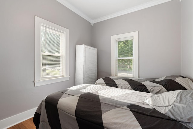 1001 2nd Ave SW, Austin, MN 55912 - bedroom featuring crown molding, wood finished floors, and baseboards
