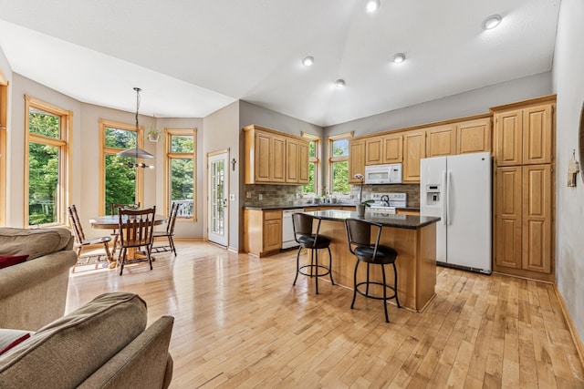 5160 202nd Ln NE, Linwood Twp, MN 55092 - kitchen with white appliances, open floor plan, light wood-type flooring, backsplash, and recessed lighting