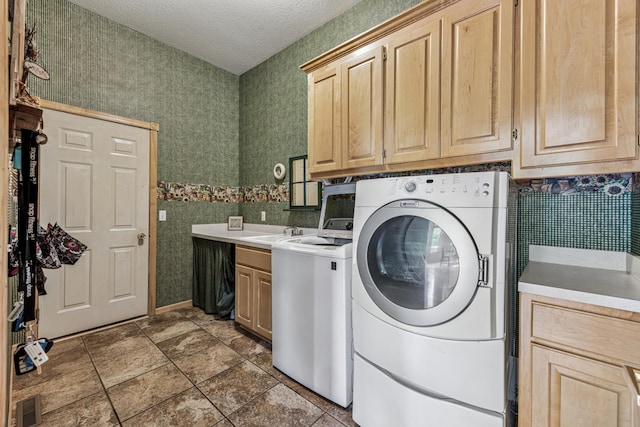 5160 202nd Ln NE, Linwood Twp, MN 55092 - laundry room featuring cabinet space, separate washer and dryer, a textured ceiling, and wallpapered walls