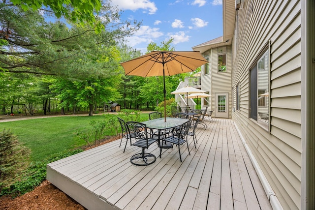 5160 202nd Ln NE, Linwood Twp, MN 55092 - deck featuring outdoor dining space and a lawn