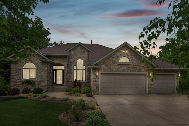 5160 202nd Ln NE, Linwood Twp, MN 55092 - french country style house with an attached garage, concrete driveway, a shingled roof, a front yard, and stone siding
