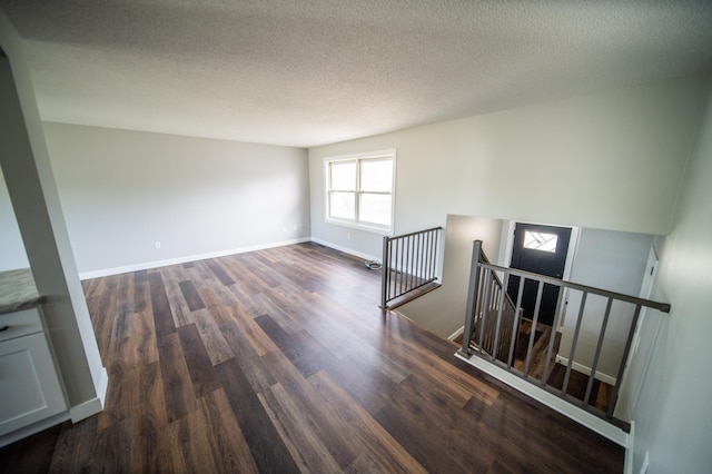 4703 7th St NW, Rochester, MN 55901 - empty room featuring wood finished floors, baseboards, and a textured ceiling