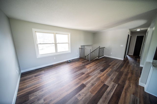 4703 7th St NW, Rochester, MN 55901 - spare room featuring dark wood-style flooring and baseboards