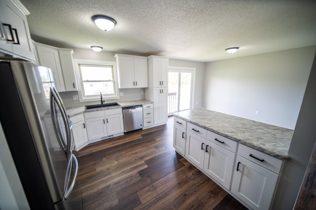 4703 7th St NW, Rochester, MN 55901 - kitchen with stainless steel appliances, a sink, a textured ceiling, dark wood-type flooring, and healthy amount of natural light