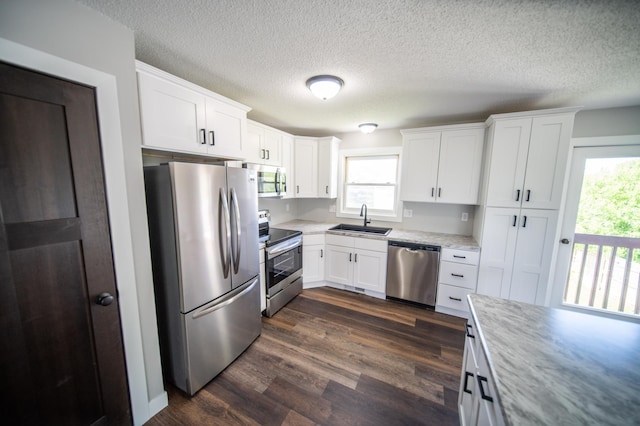 4703 7th St NW, Rochester, MN 55901 - kitchen featuring appliances with stainless steel finishes, a sink, light countertops, white cabinetry, and dark wood-style flooring