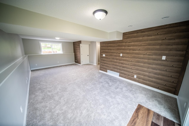 4703 7th St NW, Rochester, MN 55901 - unfurnished room with wood walls, carpet, and baseboards