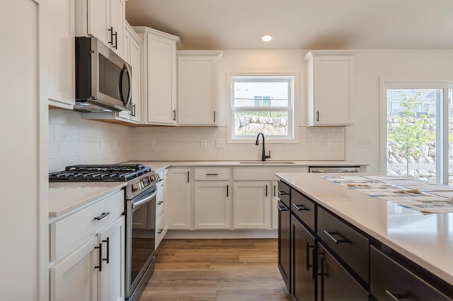 1955 Fulton Rd, Carver, MN 55315 - kitchen featuring stainless steel appliances, a sink, white cabinetry, light countertops, and recessed lighting