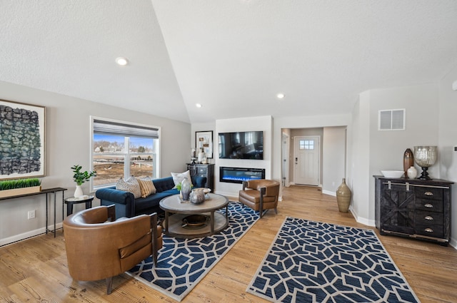 1955 Fulton Rd, Carver, MN 55315 - living area featuring vaulted ceiling, wood finished floors, baseboards, and recessed lighting