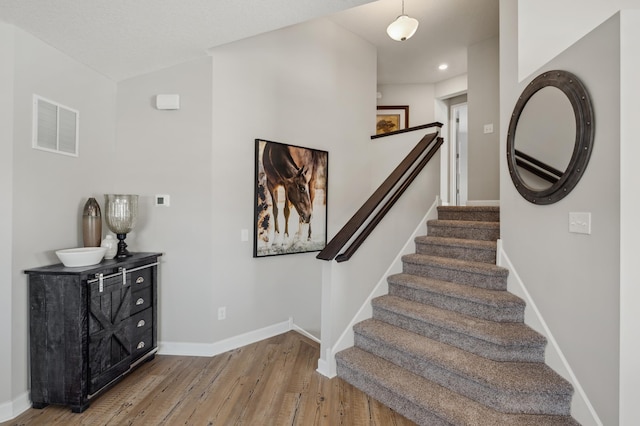 1955 Fulton Rd, Carver, MN 55315 - stairway featuring wood finished floors, baseboards, and recessed lighting