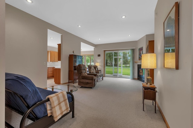 1538 Katrina Ct, Saint Cloud, MN 56301 - living room with light colored carpet, recessed lighting, baseboards, and a glass covered fireplace