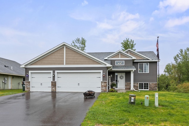 970 Acacia Dr S, Annandale, MN 55302 - view of front of house featuring asphalt driveway, stone siding, a front yard, and an attached garage
