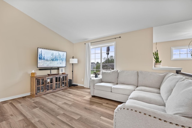 970 Acacia Dr S, Annandale, MN 55302 - living room featuring wood finished floors, baseboards, and vaulted ceiling