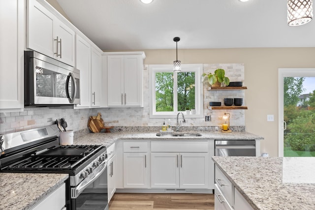 970 Acacia Dr S, Annandale, MN 55302 - kitchen with stainless steel appliances, a sink, white cabinetry, backsplash, and light wood finished floors