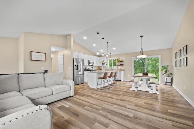 970 Acacia Dr S, Annandale, MN 55302 - living room featuring light wood-style floors, baseboards, recessed lighting, and high vaulted ceiling