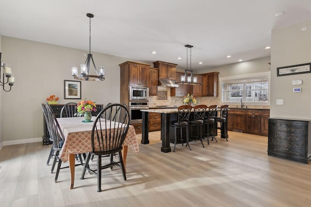 15653 Cobblestone Lake Pkwy, Apple Valley, MN 55124 - dining space featuring a chandelier, light wood-style floors, baseboards, and recessed lighting