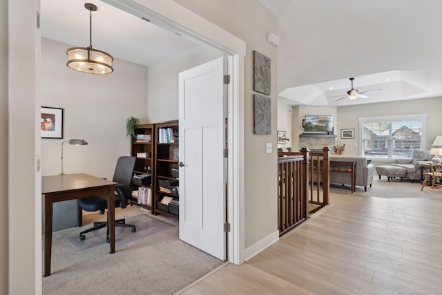 15653 Cobblestone Lake Pkwy, Apple Valley, MN 55124 - home office with a ceiling fan, light wood-type flooring, a tray ceiling, and baseboards
