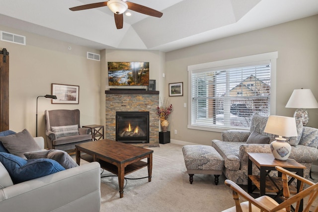 15653 Cobblestone Lake Pkwy, Apple Valley, MN 55124 - living area featuring light colored carpet, ceiling fan, a stone fireplace, and baseboards