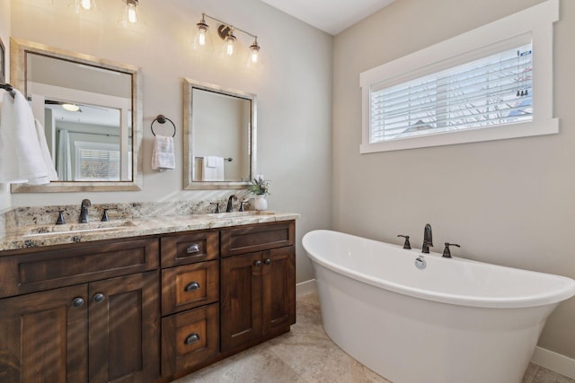 15653 Cobblestone Lake Pkwy, Apple Valley, MN 55124 - full bathroom featuring a freestanding tub, double vanity, and baseboards