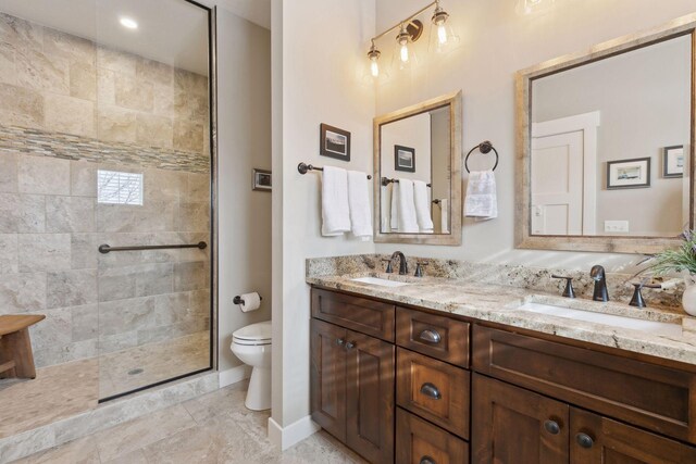 15653 Cobblestone Lake Pkwy, Apple Valley, MN 55124 - full bathroom featuring toilet, double vanity, tiled shower, and baseboards