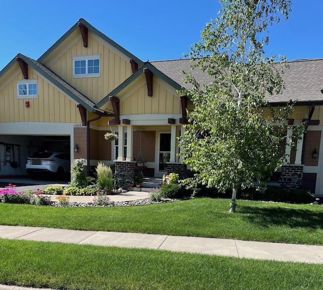 15653 Cobblestone Lake Pkwy, Apple Valley, MN 55124 - craftsman house with a front lawn, roof with shingles, a garage, and board and batten siding