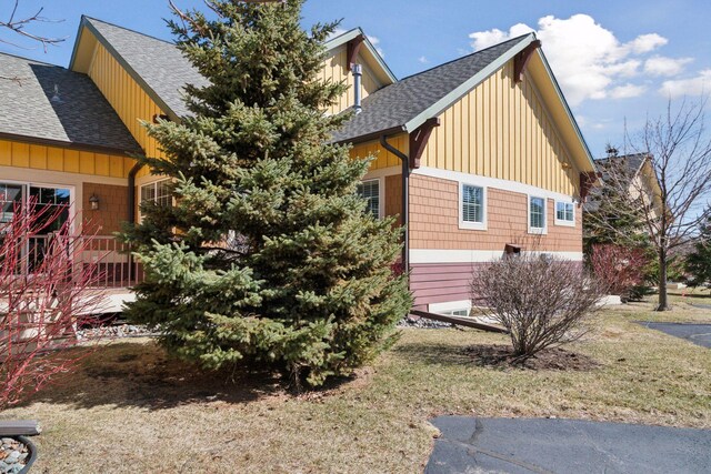 15653 Cobblestone Lake Pkwy, Apple Valley, MN 55124 - view of property exterior with roof with shingles, board and batten siding, and a yard