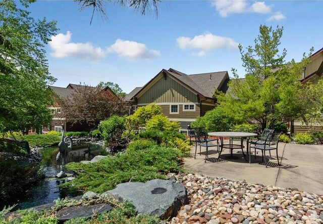15653 Cobblestone Lake Pkwy, Apple Valley, MN 55124 - view of yard with a patio area, outdoor dining area, and a garden pond