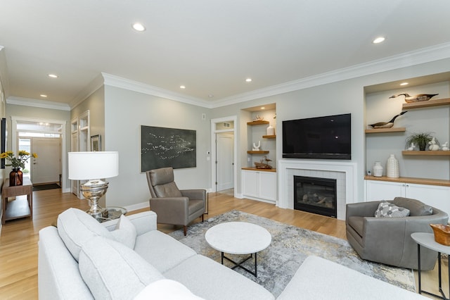 2720 Bentley Dr SW, Rochester, MN 55902 - living room with light wood-type flooring, recessed lighting, a tiled fireplace, ornamental molding, and baseboards
