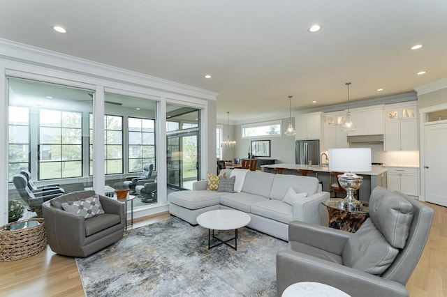 2720 Bentley Dr SW, Rochester, MN 55902 - living area with crown molding, light wood-type flooring, recessed lighting, and a chandelier