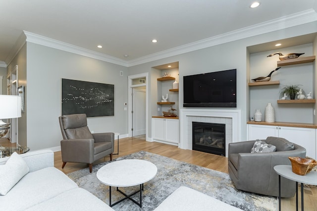 2720 Bentley Dr SW, Rochester, MN 55902 - living area with crown molding, wood finished floors, recessed lighting, a tile fireplace, and baseboards