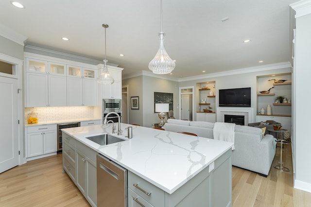 2720 Bentley Dr SW, Rochester, MN 55902 - kitchen with a sink, appliances with stainless steel finishes, light wood-style floors, a center island with sink, and white cabinets