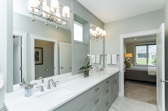 2720 Bentley Dr SW, Rochester, MN 55902 - ensuite bathroom with a chandelier, double vanity, and marble look tile flooring
