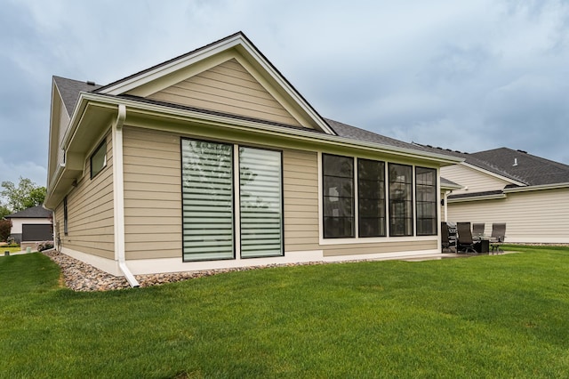 2720 Bentley Dr SW, Rochester, MN 55902 - rear view of property featuring a lawn and a shingled roof