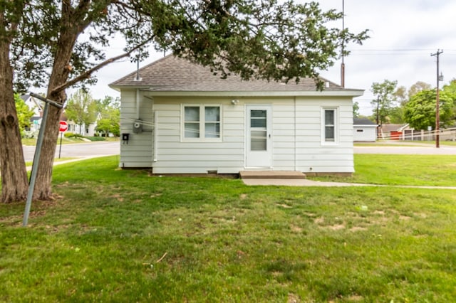 2320 3rd St N, Saint Cloud, MN 56303 - rear view of property featuring a yard and a shingled roof