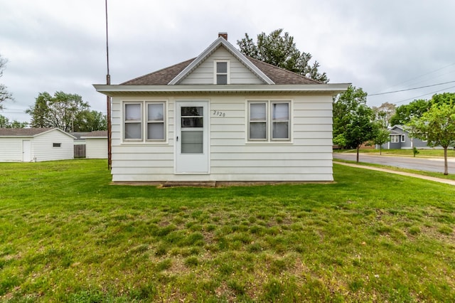 2320 3rd St N, Saint Cloud, MN 56303 - rear view of property featuring a lawn and a shingled roof