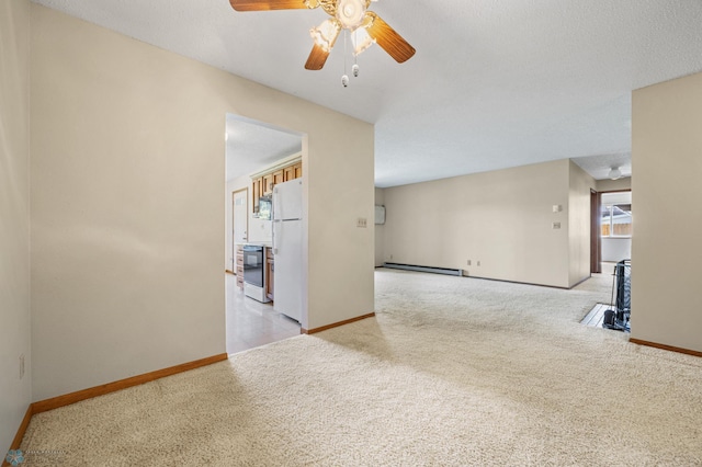 2802 29th Ave S, Moorhead, MN 56560 - spare room featuring a baseboard radiator, light carpet, a ceiling fan, and healthy amount of natural light