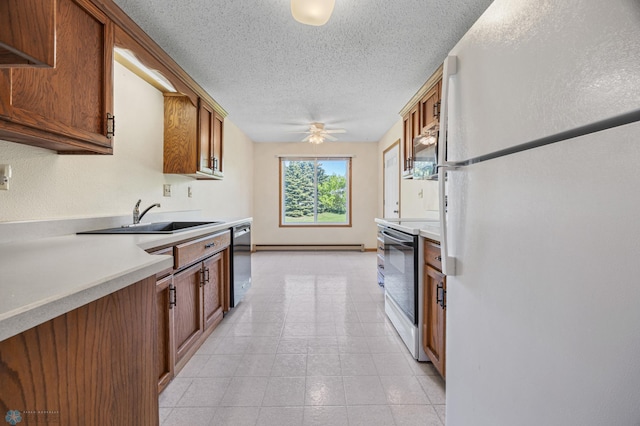 2802 29th Ave S, Moorhead, MN 56560 - kitchen with appliances with stainless steel finishes, a sink, a ceiling fan, light countertops, and brown cabinetry