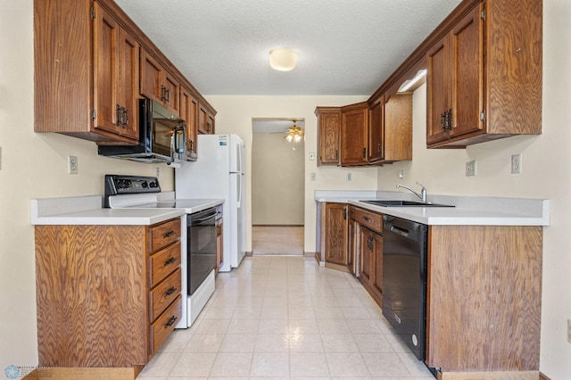 2802 29th Ave S, Moorhead, MN 56560 - kitchen featuring black appliances, a sink, ceiling fan, light countertops, and brown cabinets