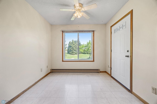 2802 29th Ave S, Moorhead, MN 56560 - spare room featuring a baseboard heating unit, a textured ceiling, baseboards, ceiling fan, and light flooring