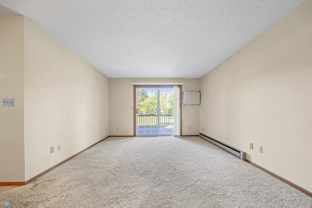 2802 29th Ave S, Moorhead, MN 56560 - carpeted spare room with a baseboard heating unit, a textured ceiling, and baseboards