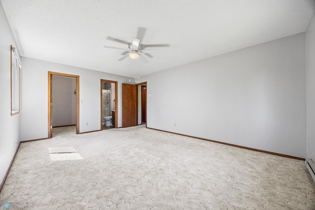 2802 29th Ave S, Moorhead, MN 56560 - unfurnished bedroom with a walk in closet, a closet, baseboards, and light carpet