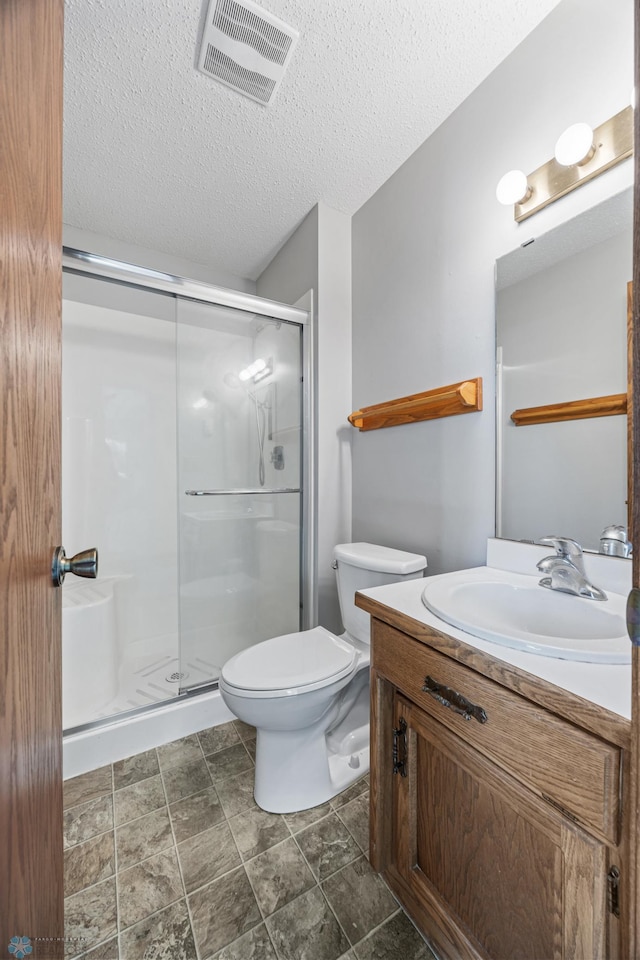 2802 29th Ave S, Moorhead, MN 56560 - full bath with vanity, a shower stall, toilet, and a textured ceiling